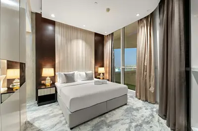 a bedroom with a white bed and a large window at FIRST CLASS 2BR Vibrant Next to Dubai Mall in Dubai