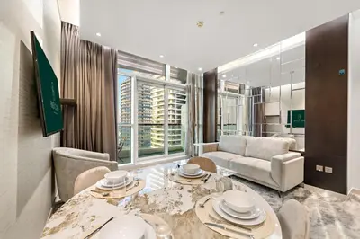 a living room with a table and a couch at FIRST CLASS 2BR Vibrant Next to Dubai Mall in Dubai