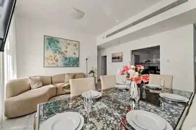 a living room with a table and a couch at VayK - Stylish 2BD in Dubai Marina Near the Beach in Dubai