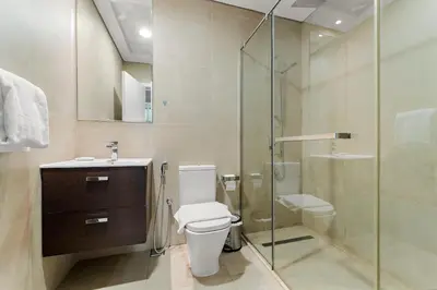 a bathroom with a toilet and a glass shower at VayK - Stylish 2BD in Dubai Marina Near the Beach in Dubai