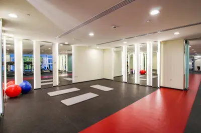 a gym with red and blue balls and white columns at VayK - Stylish 2BD in Dubai Marina Near the Beach in Dubai