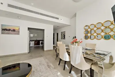 a dining room with a glass table and chairs at VayK - Stylish 2BD in Dubai Marina Near the Beach in Dubai