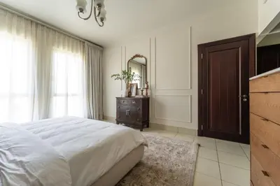 a bedroom with a bed and a dresser and a mirror at Burj Khalifa 2 BR apartment in the down town in Dubai