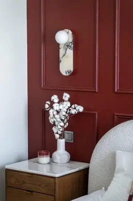 a vase with flowers on a table in a bedroom at Burj Khalifa 2 BR apartment in the down town in Dubai