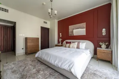 a bedroom with a large bed with a red headboard at Burj Khalifa 2 BR apartment in the down town in Dubai