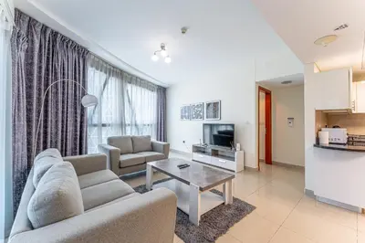 a living room with a couch and a table at HAVN - 3 bedroom in Park Towers, DIFC in Dubai