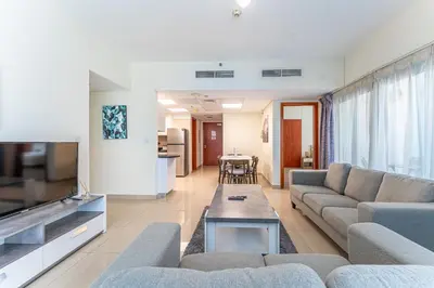 a living room with a couch and a table at HAVN - 3 bedroom in Park Towers, DIFC in Dubai