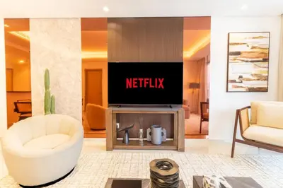 a living room with a netflix sign on the wall at Burj Khalifa View, Luxury 2B, Top Amenities and Equipment in Dubai
