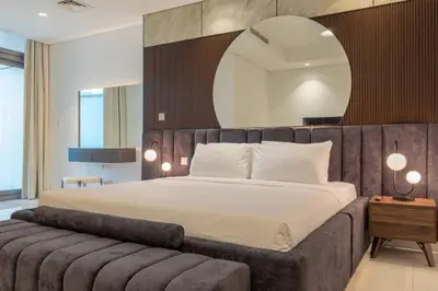 a bedroom with a large bed and a large mirror at Burj Khalifa View, Luxury 2B, Top Amenities and Equipment in Dubai