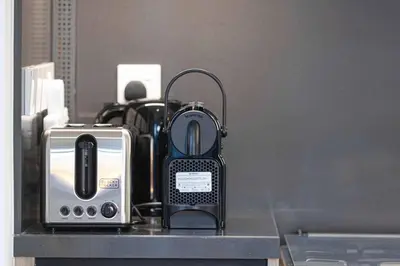 a toaster and a toaster sitting on a counter at Mahogany 25 - 2BR 10 Guests - Walk to Dubai Mall in Dubai