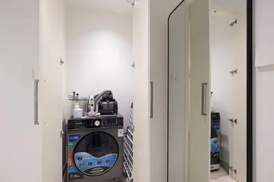 a laundry room with a washer and dryer at Mahogany 25 - 2BR 10 Guests - Walk to Dubai Mall in Dubai