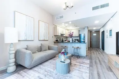 a living room with a couch and a table at Stylish Studio in JVC with Pool and Gym Access in Dubai