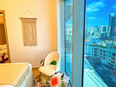 a bedroom with a balcony with a view of the city at Barsana - Azure Marina Apartment - 3Bed - Full Marina View in Dubai