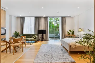 a bedroom with a bed and a living room at Serene Studio in Al Barari Near Dubai Hills Mall in Dubai