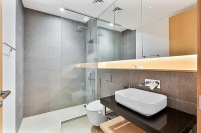 a bathroom with a sink and a toilet and a mirror at Serene Studio in Al Barari Near Dubai Hills Mall in Dubai