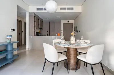 a dining room with a table and chairs at GuestReady | New 1BR with Maid’s Room | Spacious in Dubai