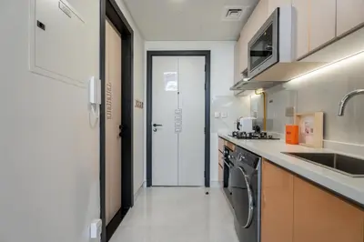 a kitchen with a sink and a stove at GuestReady - Studio Suite l Community Jacuzzi in Dubai