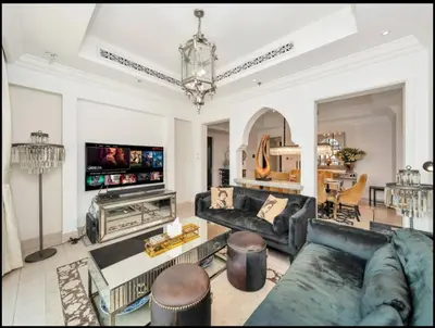 a living room with a couch and a tv at Skyline Souk 1 & 2 Bedroom Apartments I Burj Khalifa Views I Private Terrace I Gym, Pool, Parking & Wi-Fi in Dubai
