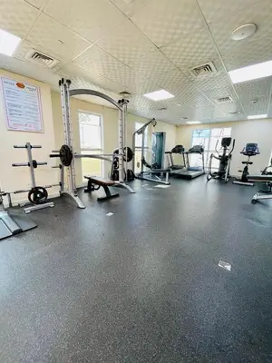a gym with several treadmills and machines at Modern Studio With Scenic Views in Dubai