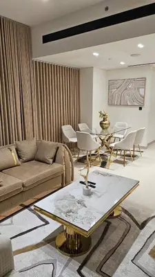 a living room with a couch and a table and chairs at LAREDA BY VIBY Vacation Homes Rental in Dubai