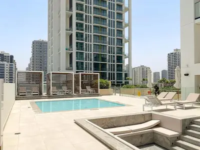 a large building with a swimming pool in a city at LAREDA BY VIBY Vacation Homes Rental in Dubai