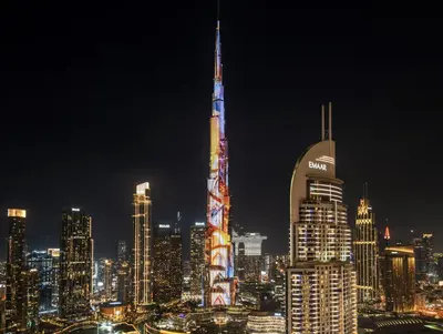 a night view of a city with a tall building at Luxurious Apartment in Downtown near Burj Khalifa in Dubai