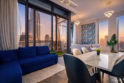 a living room with a blue couch and a table at Luxurious Apartment in Downtown near Burj Khalifa in Dubai