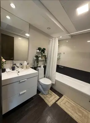 a bathroom with a toilet and a sink and a tub at Luxurious Apartment in Downtown near Burj Khalifa in Dubai