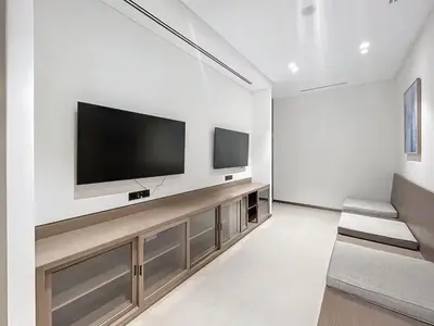 a living room with a flat screen tv on a wall at Luxurious Apartment with Burj Khalifa View in Downtown in Dubai