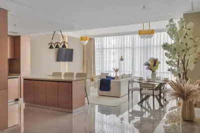 a living room with a kitchen and a dining room at Luxe 2 Bedroom Apartment in Dubai Marina in Dubai