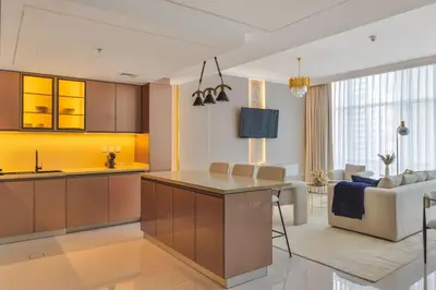a kitchen and living room with a couch and a table at Luxe 2 Bedroom Apartment in Dubai Marina in Dubai