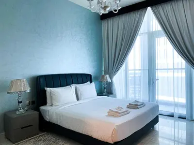 a bedroom with a bed with blue walls and a chandelier at Elegant 1BDR Sleeps 4 in Bayz-22 in Dubai