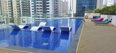 a swimming pool on the roof of a building at Elegant 1BDR Sleeps 4 in Bayz-22 in Dubai
