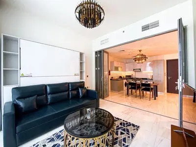 a living room with a couch and a table at Elegant 1BDR Sleeps 4 in Bayz-22 in Dubai