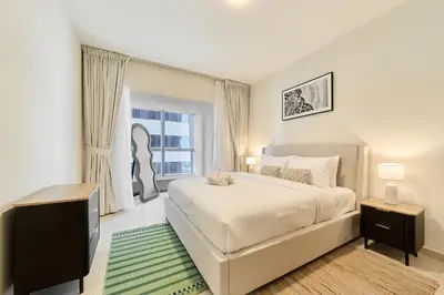 a bedroom with a large bed and a window at Cozy 1BR Apartment at Elite Residence Dubai Marina in Dubai