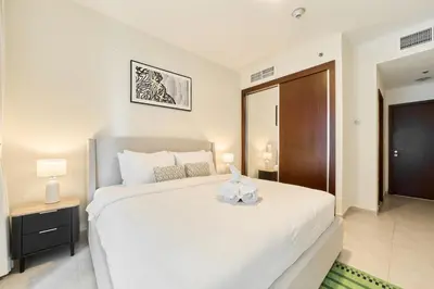 a bedroom with a large white bed in a room at Cozy 1BR Apartment at Elite Residence Dubai Marina in Dubai