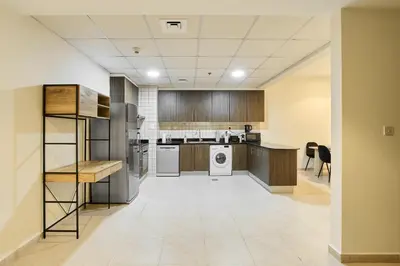 a large kitchen with a washer and dryer at Cozy 1BR Apartment at Elite Residence Dubai Marina in Dubai