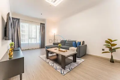 a living room with a couch and a table at Compact 1BR, Just A Minute Drive to At the Top Burj Khalifa - Ontario Tower, Business Bay in Dubai