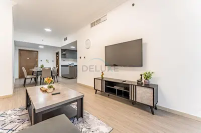 a living room with a flat screen tv on a wall at Compact 1BR, Just A Minute Drive to At the Top Burj Khalifa - Ontario Tower, Business Bay in Dubai