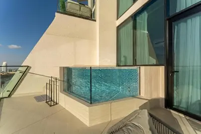a swimming pool on the balcony of a building at HAVN - High floor 1BR with Private Sky Pool, JVC in Dubai