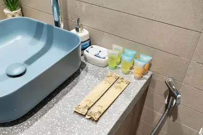 a bathroom counter with a sink and some glasses on it at Stylish 1BR Apartment Peninsula One Business Bay in Dubai