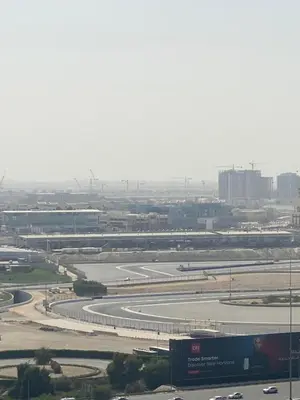 a view of an airport with a runway and buildings at Chic Studio near Miracle Garden & GlobalVillage in Dubai