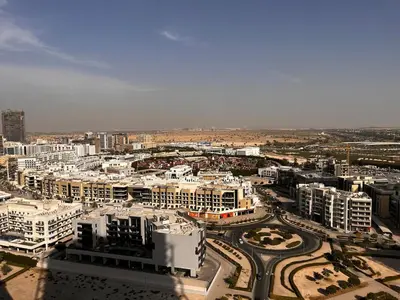 an aerial view of a city with buildings and roads at Chic Studio near Miracle Garden & GlobalVillage in Dubai