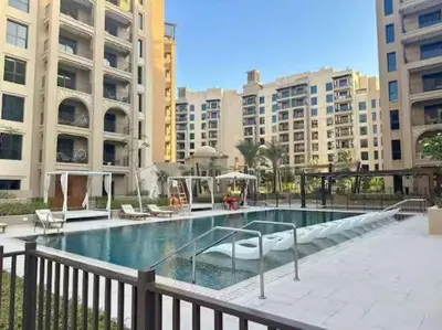 a large swimming pool in a city with buildings at Vogue Madinat Jumeirah Living Jadeel near Burj AlArab, One-Bedroom Apartment with Large Balcony and Pool View, Access to All Amenities in Dubai