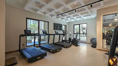 a gym with several elliptical machines in a room at Vogue Madinat Jumeirah Living Jadeel near Burj AlArab, One-Bedroom Apartment with Large Balcony and Pool View, Access to All Amenities in Dubai
