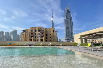 a swimming pool in a city with tall buildings at LUX 2BR High Floor - Near Dubai Mall in Dubai