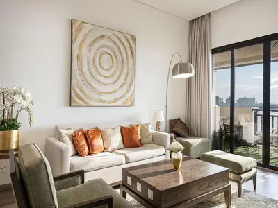a living room with a couch and a table at Livin' Holidays - 2 BR - Anantara Beach View in Dubai