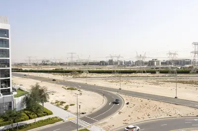 a road in the middle of a city with a building at Bright Studio with Balcony Close to Downtown Dubai in Dubai