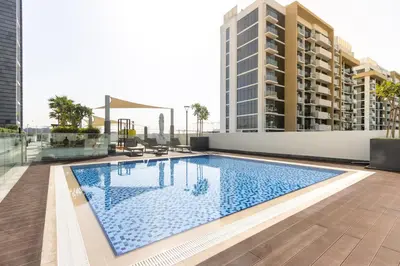 a swimming pool on the roof of a building at Bright Studio with Balcony Close to Downtown Dubai in Dubai