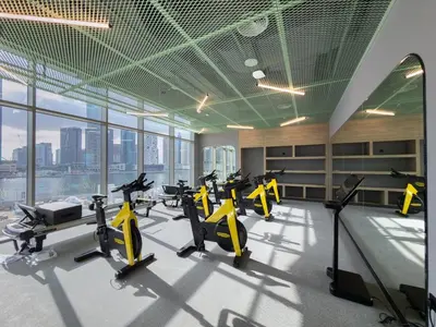 a gym with a row of treadmills and exercise bikes at Mystic - Luxe 1BR Apt with Burj Khalifa & Canal Views in Dubai